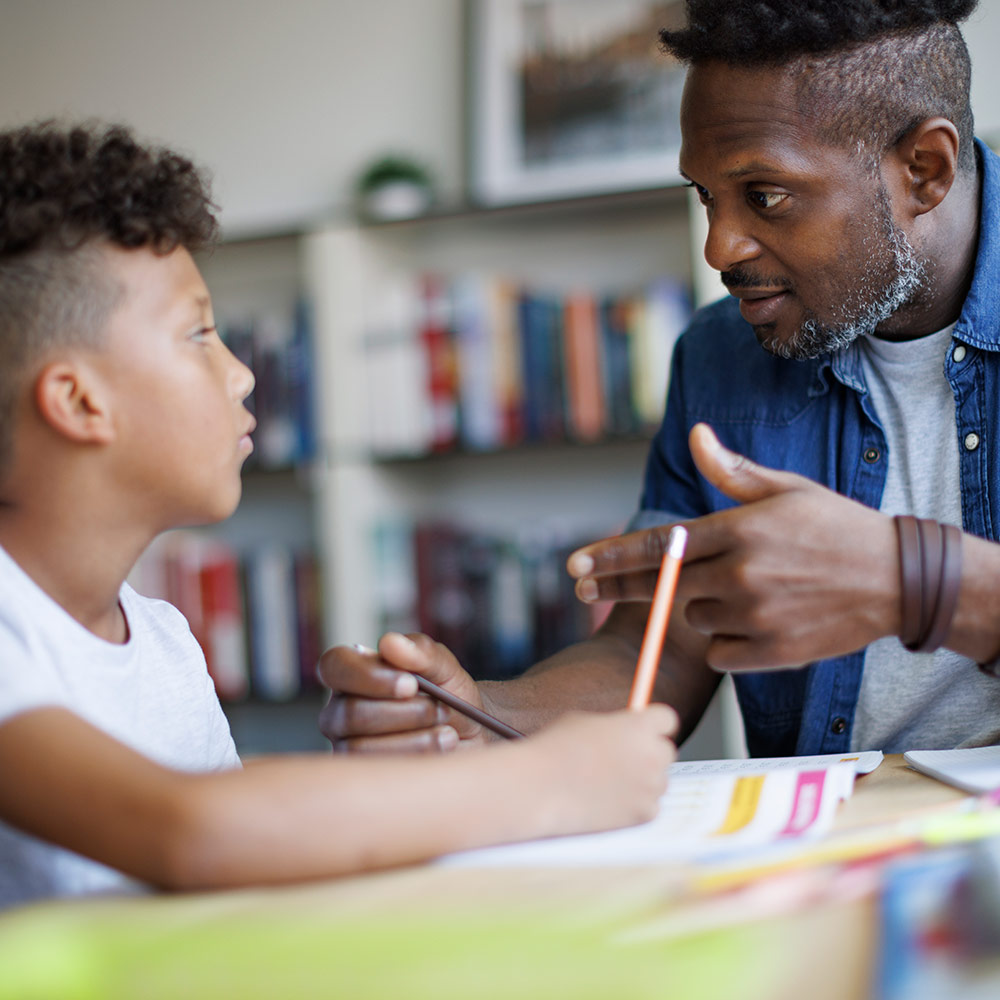 man mentoring young boy